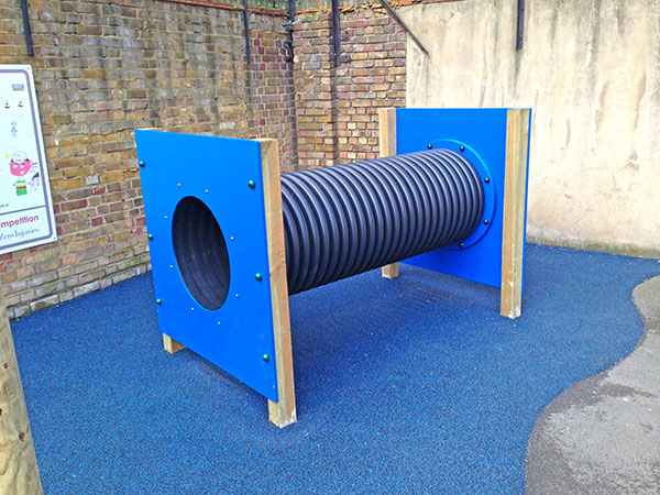 Crawl tunnel and safety surface installed as - part of a series of playground upgrades
