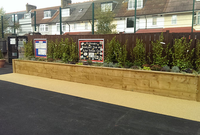 New installed wooden plating area at front on school to lift the environment